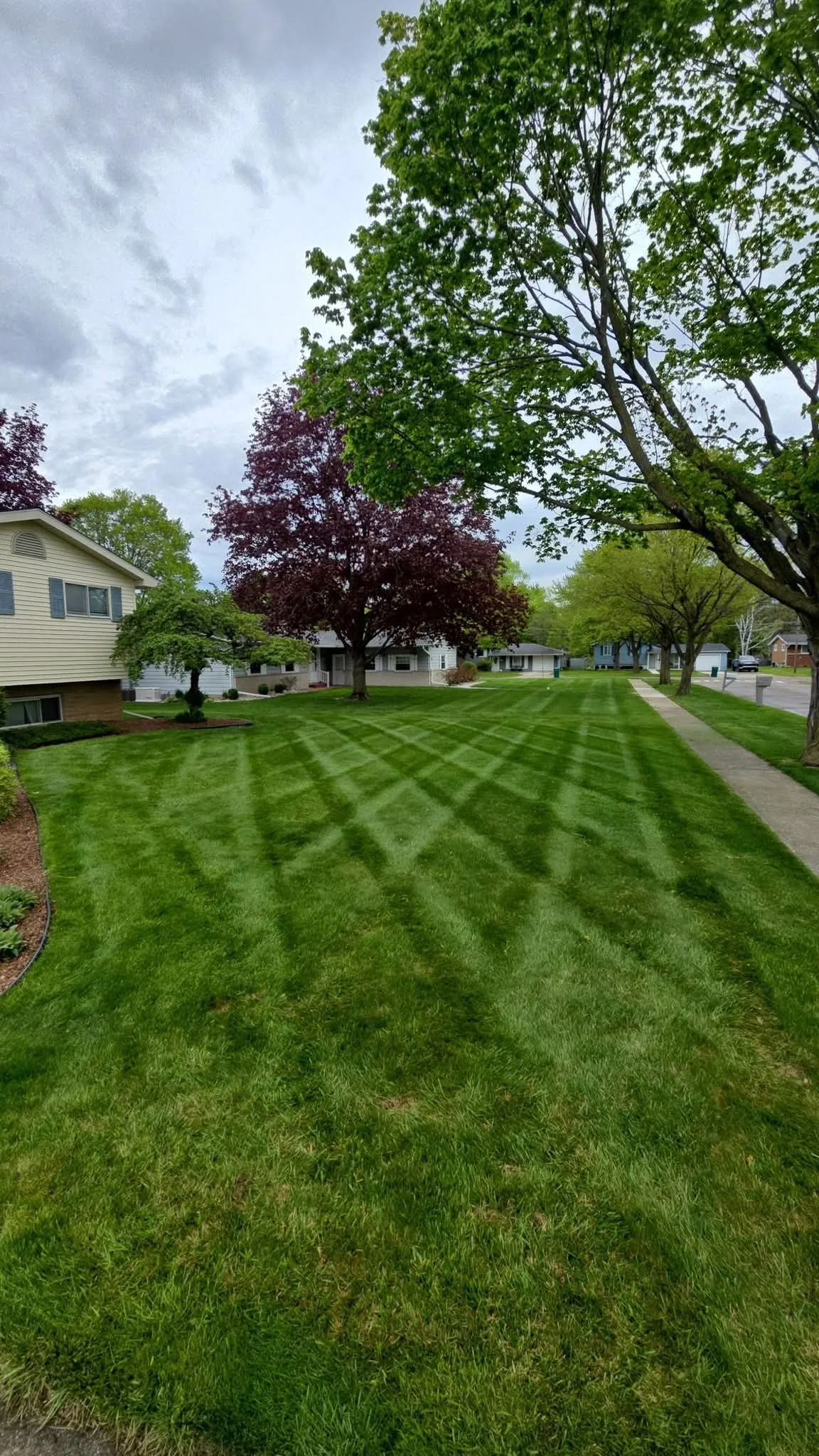 Striped residential lawn completed by Aiden's Lawn Care